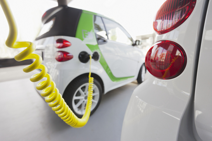 An electrically powered Smart car being charged at an electric vehicle charging station on display at the Zurich Motor Show in Zurich, Switzerland, on November 9, 2012. *** background slightly retouched ***